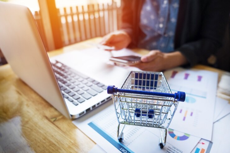 cropped-image-woman-inputting-card-information-key-phone-laptop-while-shopping-online_1423-70