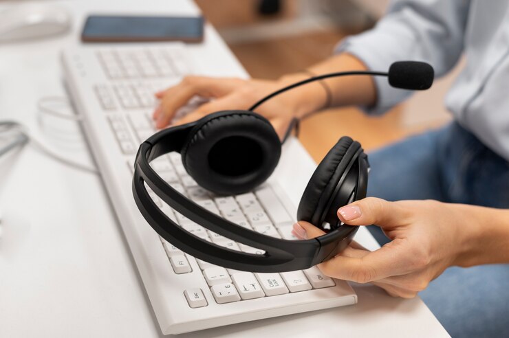 woman-working-call-center-holding-pair-headphones_23-2149256146
